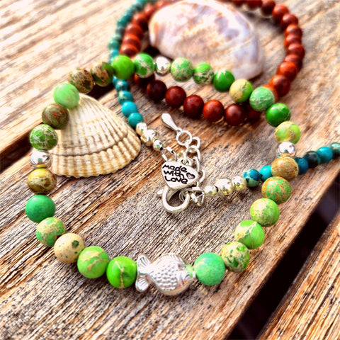 This super cute handmade bracelet features 6mm green imperial jasper beads paired with sterling silver accents and an adorable fish charm. Stretchy and comfy, it fits most adult wrists up to 7.5 inches (19cm). Perfect for anyone who adores the sea!

**Presented in lovely Kraft paper gift box with reusable organza pouch**