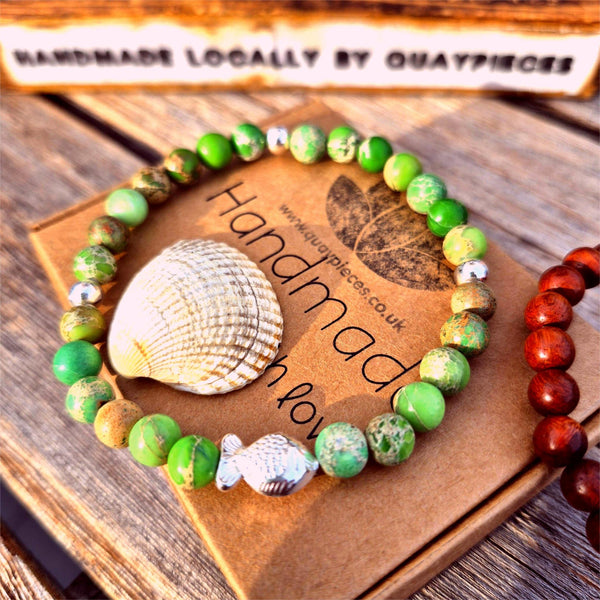 This super cute handmade bracelet features 6mm green imperial jasper beads paired with sterling silver accents and an adorable fish charm. Stretchy and comfy, it fits most adult wrists up to 7.5 inches (19cm). Perfect for anyone who adores the sea!

**Presented in lovely Kraft paper gift box with reusable organza pouch**