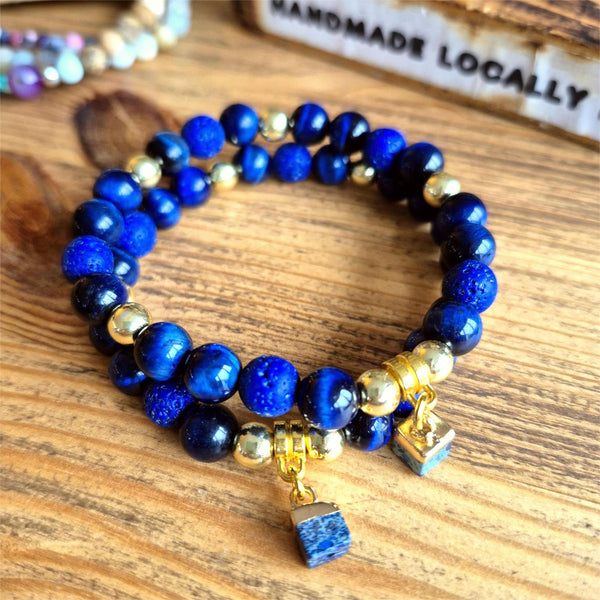 Beautiful 8mm navy blue tiger's eye bead bracelet featuring gold-plated accent beads and an elegant square stone charm. 