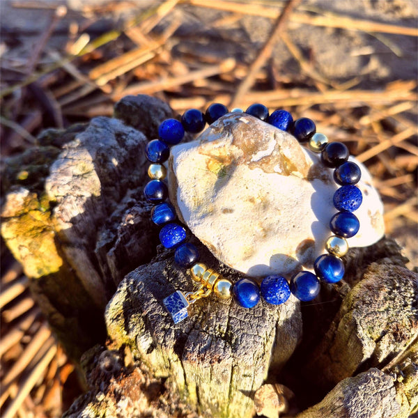 Beautiful 8mm navy blue tiger's eye bead bracelet featuring gold-plated accent beads and an elegant square stone charm. 