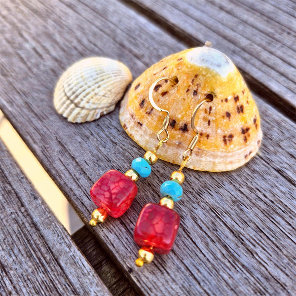 Large crimson agate cubes with turquoise stone discs &amp; gold plated beads make these earrings a playful touch to your outfits! Height from bottom of hook 25mm. Gold Plated Hooks.