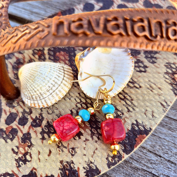 Large crimson agate cubes with turquoise stone discs &amp; gold plated beads make these earrings a playful touch to your outfits! Height from bottom of hook 25mm. Gold Plated Hooks.