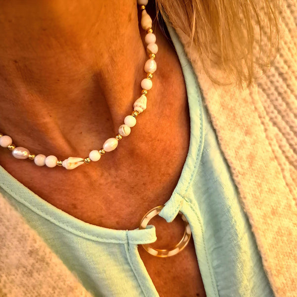 Gorgeous handmade short necklace features 4mm white jade beads &amp; white spiral shells paired with shining gold-plated beads and a secure lobster clasp. Plus a tiny gold spiral shell &amp; extension chain with cute fish charm completes the look. Measuring 43cm, it’s the perfect playful touch to wear solo or layered with your favourite pieces.