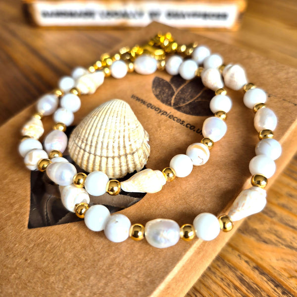Gorgeous handmade short necklace features 4mm white jade beads &amp; white spiral shells paired with shining gold-plated beads and a secure lobster clasp. Plus a tiny gold spiral shell &amp; extension chain with cute fish charm completes the look. Measuring 43cm, it’s the perfect playful touch to wear solo or layered with your favourite pieces.