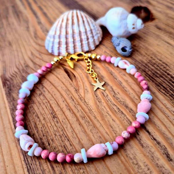 Lovely pastel pink anklet, handmade with 4mm imperial jasper beads, shell discs and pink spiral shells. Perfect for beach wear and summer styling, this delicate piece features gold-plated fastenings, a lobster clasp, and a charming conch shell and star charm (nickel free). Adjustable from 24cm to 27cm with an extension chain.&nbsp;