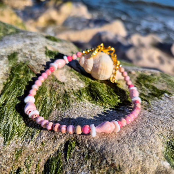 Lovely pastel pink anklet, handmade with 4mm imperial jasper beads, shell discs and pink spiral shells. Perfect for beach wear and summer styling, this delicate piece features gold-plated fastenings, a lobster clasp, and a charming conch shell and star charm (nickel free). Adjustable from 24cm to 27cm with an extension chain.&nbsp;