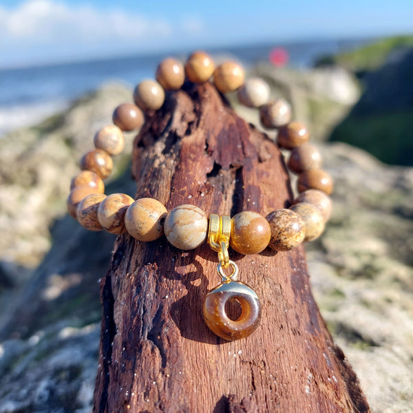 8mm Brown Marble Effect Natural Stone Bead Bracelet with gold plated circular charm Elasticated, so will fit most adult wrists (measuring 71/2 in/19cm) Perfect for wearing with those winter outfits & a lovely gift for friends or family **Presented in lovely Kraft paper gift box with reusable organza pouch**
