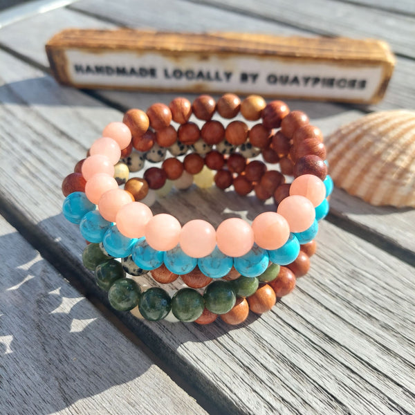 ﻿Cool handmade bracelets made with 8mm wood & natural stone beads  Choose from Pink Quartz, Turquoise Calcite, Dalmatian Jasper, Green Serpentine or Multi Aqua natural stone   Because this is a natural product, no bead is the same  Elasticated, so will fit most adult wrists (measuring 71/2 in/19cm)  **Presented in lovely Kraft paper gift box with reusable organza pouch**