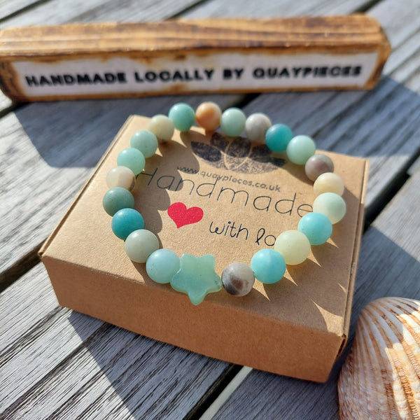 Lovely 8mm natural matt stone bead bracelet with star - available in 2 colours  1) Peach 2)Aqua green   Perfect for stacking or wearing alone!  Elasticated, so will fit most adult wrists (measuring 71/2 in/19cm)  Lovely gift for friends or family  **Presented in lovely Kraft paper gift box with reusable organza pouch**