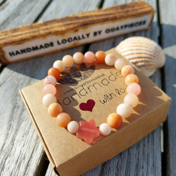 Lovely 8mm natural matt stone bead bracelet with star - available in 2 colours  1) Peach 2)Aqua green   Perfect for stacking or wearing alone!  Elasticated, so will fit most adult wrists (measuring 71/2 in/19cm)  Lovely gift for friends or family  **Presented in lovely Kraft paper gift box with reusable organza pouch**