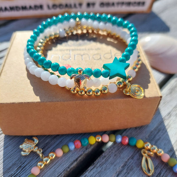 <p data-mce-fragment="1">Gorgeous Handcrafted Collection of 3 Delicate Beaded Bracelets</p> <p data-mce-fragment="1">Each Bracelet is individually designed, (1) 4mm natural white jade beads with cute 18k gold plated turtle (2) 4mm turquoise magnesite beads with star (3) 4mm 18k gold plated beads with hanging swirl charm</p> <p data-mce-fragment="1">Wear altogether or separately for a boho/Surf Chick look!</p>