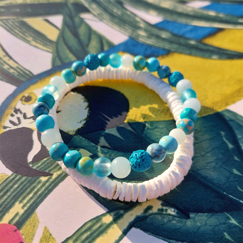 Super cool handcrafted collection of 2 Beaded Bracelets

Each Bracelet is individually designed one with white puka shell &amp; the second with 6mm multi blue or green colour stone/lava/wood &amp; glass beads.&nbsp;
A perfect Summer combination!

Elasticated, so will fit most adult wrists (measuring 7.5 in/19cm)


**Presented in lovely Kraft paper gift box with reusable organza pouch**