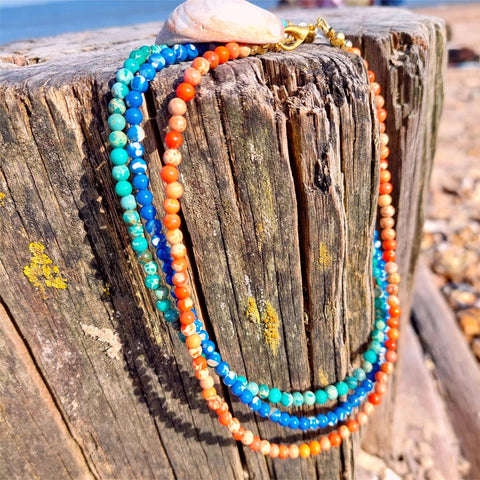 Lovely simple short necklace,, handmade with 4mm natural imperial jasper stone beads


Available in 3 colours - Orange with gold plated fastenings &amp; lobster clasp&nbsp;with gold (nickel free) star &amp; fish charm or Green or Blue with silver plated fastenings &amp; lobster clasp with 'made with love' heart (nickel free)


Length - 36cm with extension chain to 41cm

Perfect for wearing with all your favourite Tees!
