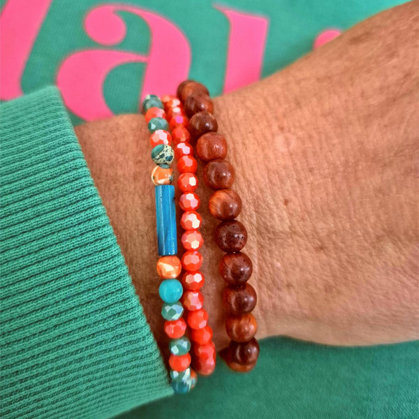 Add a pop of color to your summer looks with these handcrafted, delicate bracelets made with 4mm &amp; 6mm beads. Each one is unique, featuring turquoise &amp; orange stone beads with shell tubes, coral faceted glass, and natural waxed wood. They fit most adult wrists perfectly with their close-fitting elastic design (measuring 7.5 in/19cm). Perfect for adding a touch of fun and flair to your summer wardrobe!