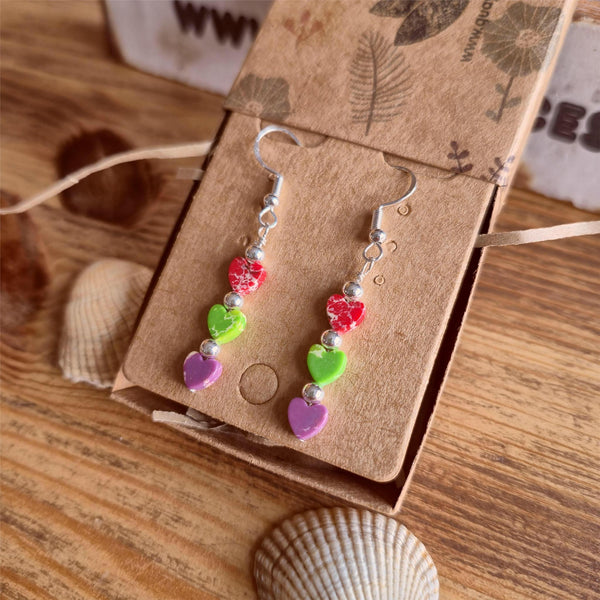These super cute earrings are crafted from 925 Hall Marked Sterling Silver, featuring handmade sterling silver beads and 6mm marbled stone hearts in playful shades of purple, green, and red. Measuring 30mm from the hook’s base, they’re the perfect pop of colour to brighten your summer wardrobe. A delightful gift for a friend or a fun treat just for you!