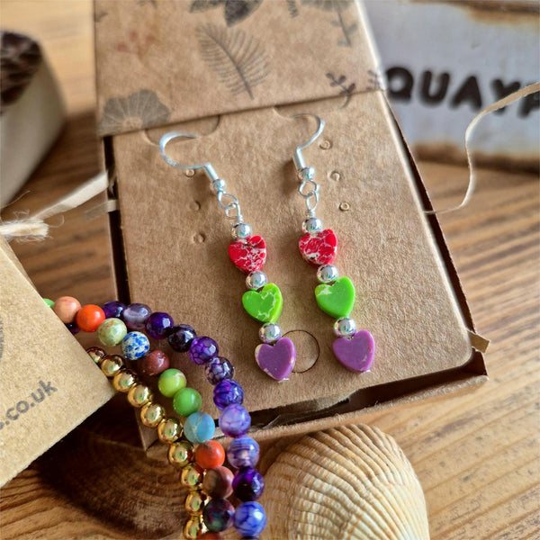 These super cute earrings are crafted from 925 Hall Marked Sterling Silver, featuring handmade sterling silver beads and 6mm marbled stone hearts in playful shades of purple, green, and red. Measuring 30mm from the hook’s base, they’re the perfect pop of colour to brighten your summer wardrobe. A delightful gift for a friend or a fun treat just for you!