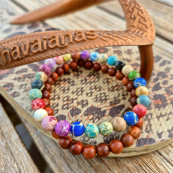 Super cool handcrafted collection of 2 Beaded Bracelets

A duo of 6mm waxed natural wood beads &amp; 6mm multi colour imperial jasper beads
A perfect Summer combination!

Elasticated, so will fit most adult wrists (measuring 7.5 in/19cm)


**Presented in lovely Kraft paper gift box with reusable organza pouch**