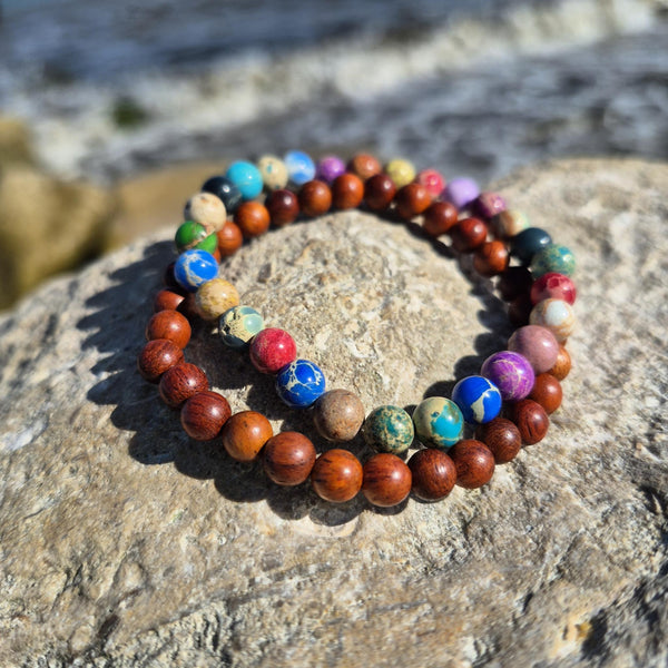 Super cool handcrafted collection of 2 Beaded Bracelets

A duo of 6mm waxed natural wood beads &amp; 6mm multi colour imperial jasper beads
A perfect Summer combination!

Elasticated, so will fit most adult wrists (measuring 7.5 in/19cm)


**Presented in lovely Kraft paper gift box with reusable organza pouch**