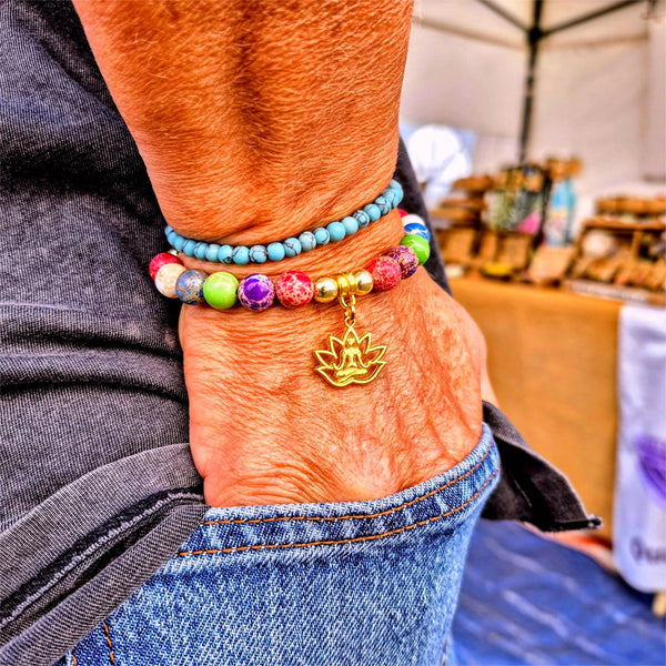Colorful beaded bracelets on a wrist with a blurred background