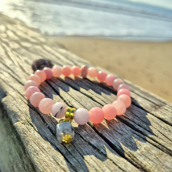 Pixie is the perfect pop of colour for your wrist! This super cute bracelet features delicate 8mm pink stone beads paired with a charming grey square glass accent &amp; opal disc that adds just the right touch of sophistication. Whether you're brightening up your everyday look or searching for a thoughtful gift, this little beauty delivers instant joy and style.
