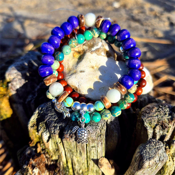 Discover three stunning handmade bracelets that work beautifully together. This vibrant trio features 8mm purple wood beads with coconut discs, aqua stone beads &amp; silver turtle (nickel free), 6mm waxed natural wood beads paired with 6mm green imperial jasper beads with cute silver plated fish.