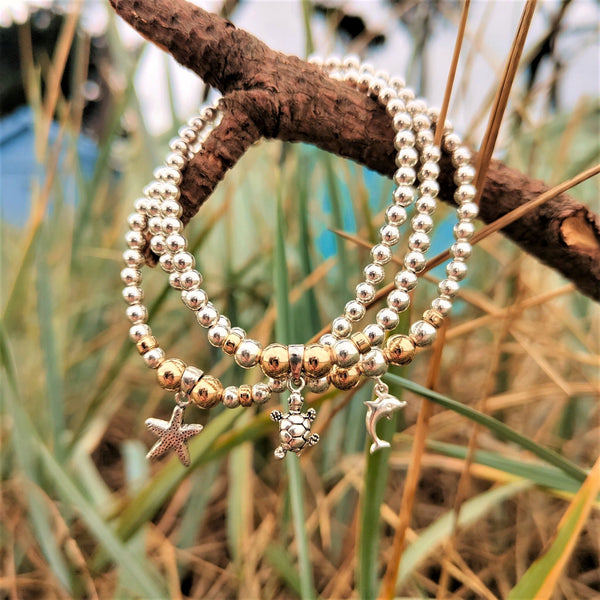 ﻿﻿Lovely Handmade Sterling Silver & gold filled bead bracelets with sea creature charm.  4mm Sterling Silver & gold filled beads with choice of Dolphin, Turtle & Starfish charm  Elasticated, so will fit most adult wrists (measuring 71/2 in/19cm)  Super cute bracelet to wear alone or as a stack!  Presented in lovely Kraft paper gift box with pretty reusable organza pouch