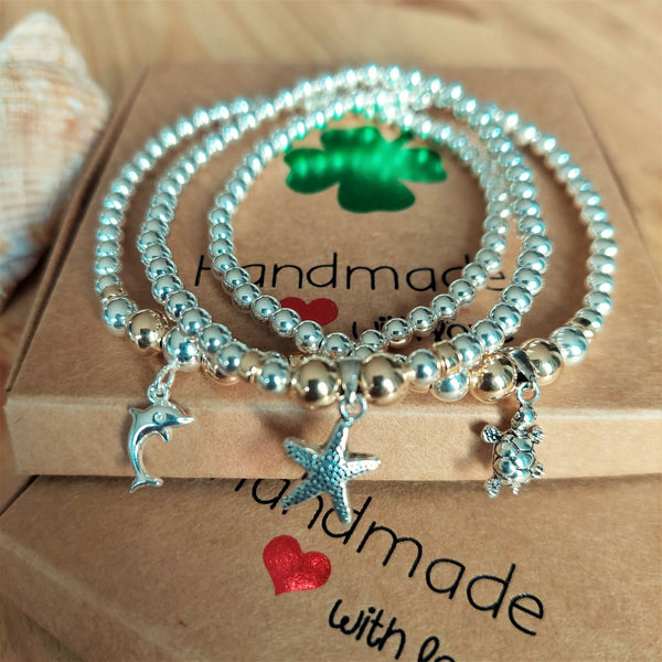 ﻿﻿Lovely Handmade Sterling Silver & gold filled bead bracelets with sea creature charm.  4mm Sterling Silver & gold filled beads with choice of Dolphin, Turtle & Starfish charm  Elasticated, so will fit most adult wrists (measuring 71/2 in/19cm)  Super cute bracelet to wear alone or as a stack!  Presented in lovely Kraft paper gift box with pretty reusable organza pouch