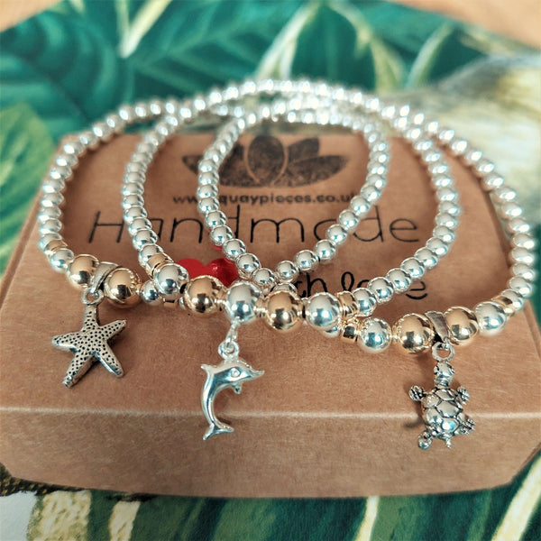 ﻿﻿Lovely Handmade Sterling Silver & gold filled bead bracelets with sea creature charm.  4mm Sterling Silver & gold filled beads with choice of Dolphin, Turtle & Starfish charm  Elasticated, so will fit most adult wrists (measuring 71/2 in/19cm)  Super cute bracelet to wear alone or as a stack!  Presented in lovely Kraft paper gift box with pretty reusable organza pouch