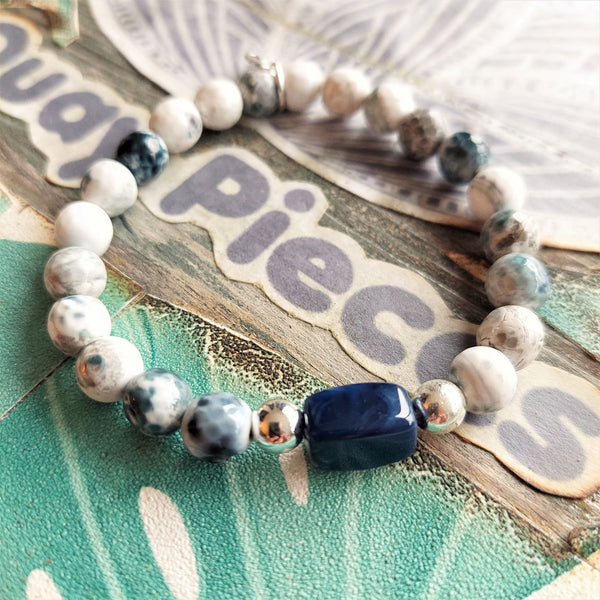 ﻿8mm semi precious faceted cut stone bead bracelet in white/grey/navy opal colour with blue rectangle charm & made with love heart (nickel free)  ﻿Elasticated, so will fit most adult wrists (measuring 71/2 in/19cm)  Lovely gift for friends or family  **Presented in lovely Kraft paper gift box with reusable organza pouch**