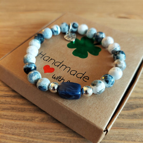﻿8mm semi precious faceted cut stone bead bracelet in white/grey/navy opal colour with blue rectangle charm & made with love heart (nickel free)  ﻿Elasticated, so will fit most adult wrists (measuring 71/2 in/19cm)  Lovely gift for friends or family  **Presented in lovely Kraft paper gift box with reusable organza pouch**
