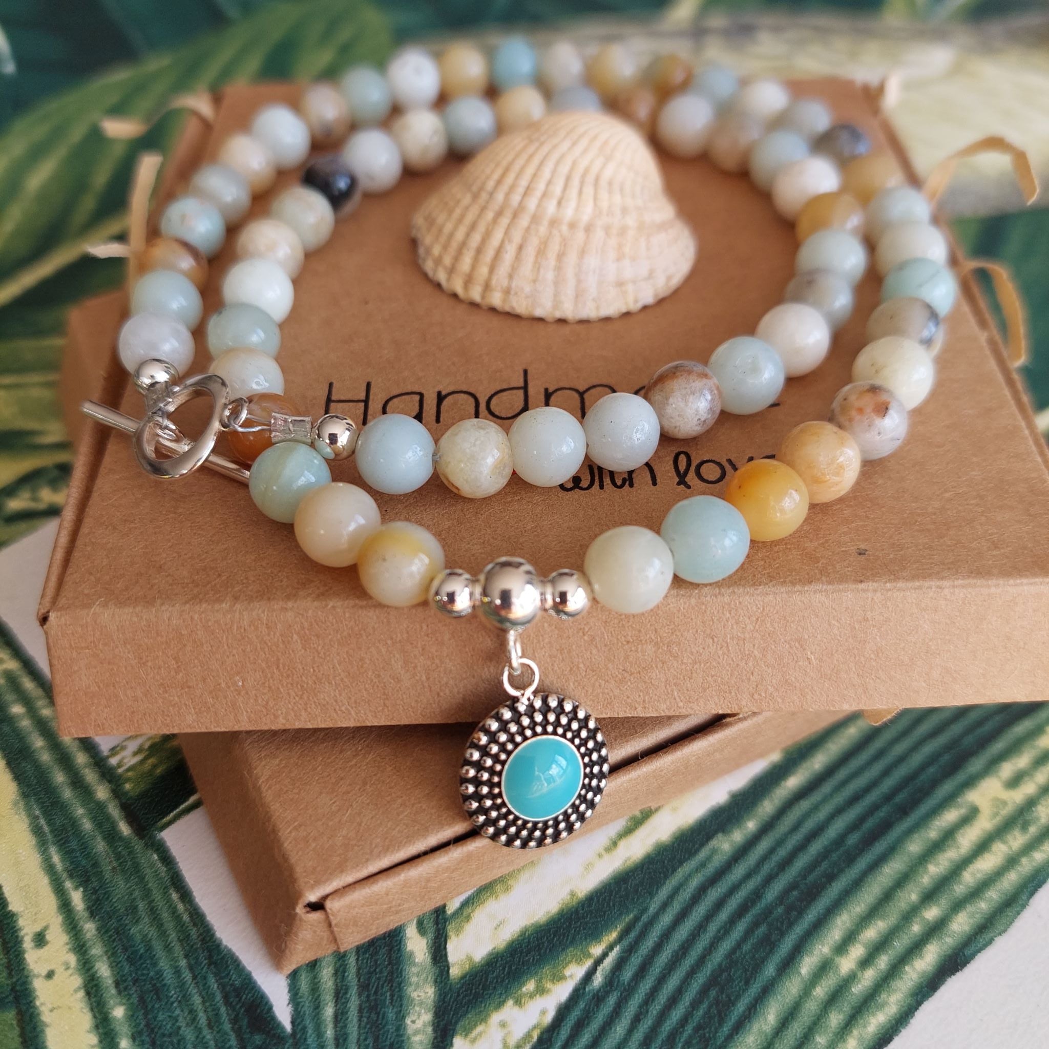 Gorgeous natural stone bead necklace with sterling silver beads & toggle fastening with choice of silver charm.  Length - 42cm  Choose from 1) Yellow beads with starfish                       2) Aqua/brown beads with turquoise circle  A lovely addition to all those summer outfits & Super cute gift for any beach lover!  **Presented in lovely Kraft paper gift box with reusable organza pouch**